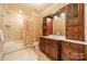 Bathroom with a shower/tub combo and wood vanity at 8215 Buena Vista Dr, Denver, NC 28037