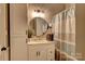 Clean bathroom with white vanity, a round mirror, and shower/tub combo at 101 Pine Ave, Cherryville, NC 28021