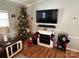 Living room decorated for the holidays with fireplace, Christmas tree, and stockings at 108 Elm St, New London, NC 28127