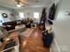 Cozy living room with a sectional sofa, hardwood floors, and festive holiday decor at 108 Elm St, New London, NC 28127