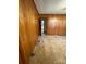 Simple living room with wood paneled walls and carpeting at 112 Adcock St, Belmont, NC 28012