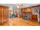 Living room with a cozy fireplace, wood paneling, and hardwood floors at 1755 N Main St, China Grove, NC 28023