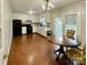 Eat-in kitchen with white cabinets, black appliances, and wood-look floors at 212 Pine St, Rockwell, NC 28138