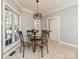 Breakfast nook with glass-top table and four chairs, near kitchen and backyard access at 3203 Bentley Dr, Lancaster, SC 29720