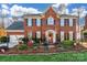 Two-story brick home with landscaped yard and charming holiday decorations at 5525 Providence Glen Rd, Charlotte, NC 28270