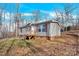 Gray single-story home with maroon shutters and a wooden deck at 633 Lhasa Apso Ln, Iron Station, NC 28080