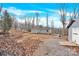 Grey house exterior with wooden deck and surrounding trees at 633 Lhasa Apso Ln, Iron Station, NC 28080