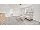 Spacious living room featuring gray flooring, a white couch, and ample natural light at 633 Lhasa Apso Ln, Iron Station, NC 28080