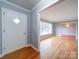 Inviting entryway with hardwood floors, leading to the dining room at 7218 Melody Ln, Charlotte, NC 28214