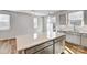 Modern kitchen with gray cabinets, white quartz countertops, and stainless steel appliances at 8100 Downy Oak Ln, Charlotte, NC 28269