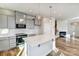 Modern kitchen with gray cabinets, quartz countertops, and stainless steel appliances at 8100 Downy Oak Ln, Charlotte, NC 28269