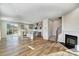 Open living space featuring hardwood floors, fireplace, and kitchen island at 8100 Downy Oak Ln, Charlotte, NC 28269