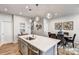 Modern kitchen island with seating and a view of the dining area at 8112 Downy Oak Ln, Charlotte, NC 28269