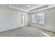 Spacious bedroom with neutral walls and carpet, featuring two windows at 8116 Downy Oak Ln, Charlotte, NC 28269