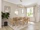 Bright dining area with a wooden table, chairs, and a stylish rug at 8912 Connover Hall Ave, Charlotte, NC 28215