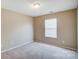 Spacious bedroom with window and ceiling light at 9315 Ames Hollow Rd, Charlotte, NC 28216