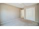 Simple bedroom with double door closet and access to hallway at 9315 Ames Hollow Rd, Charlotte, NC 28216