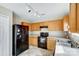 Bright kitchen features wood cabinets, black appliances, and tile floors at 9315 Ames Hollow Rd, Charlotte, NC 28216