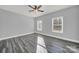 Bright bedroom with ceiling fan and grey wood-look flooring at 10225 Nugget Place Rd, Midland, NC 28107