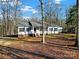 One-story home, covered porch, and outbuilding at 10225 Nugget Place Rd, Midland, NC 28107