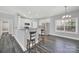 Kitchen with island seating, stainless steel appliances, and grey wood-look floors at 10225 Nugget Place Rd, Midland, NC 28107