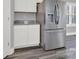 Stainless steel refrigerator in a kitchen with white cabinets and granite countertops at 10225 Nugget Place Rd, Midland, NC 28107