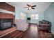 Living room features a brick fireplace and hardwood floors at 1330 Crestview Dr, Shelby, NC 28150