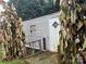 Exterior view of a single-story home with a wooden deck and large plants at 215 W Ohio Ave, Bessemer City, NC 28016