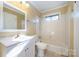 Clean bathroom with white vanity, shower/tub combo and tiled walls at 2809 Markland Dr, Charlotte, NC 28208