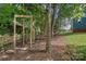 Backyard with wooden fitness equipment and trees at 4131 Huntmeadow Dr, Charlotte, NC 28269