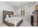 Bedroom with tufted headboard and window seating at 5056 Bridge Way, Denver, NC 28037