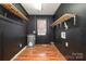 Laundry area with wood flooring and shelving at 1055 Laurel Ave, Lancaster, SC 29720