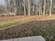 Spacious, wooded backyard with fallen leaves at 120 Orville Rd, Statesville, NC 28677