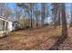 Wooded backyard with leaf-covered ground at 12813 Peppercorn Ln, Midland, NC 28107