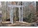 White wooden arbor in wooded backyard setting at 1437 Autumn Ridge Ln, Fort Mill, SC 29708