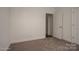 Spacious bedroom with neutral carpet and an open door at 168 Wylie Trl, Statesville, NC 28677
