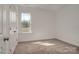 Bright bedroom with neutral carpeting and large window at 168 Wylie Trl, Statesville, NC 28677