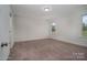 Bright bedroom with neutral carpeting and two windows at 168 Wylie Trl, Statesville, NC 28677