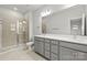 Double vanity bathroom with a large mirror and a walk-in shower at 1732 Blanche St, Charlotte, NC 28262