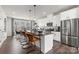 Open concept kitchen boasting stainless steel appliances and an island with seating at 1736 Blanche St, Charlotte, NC 28262