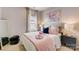 Well-lit bedroom featuring a queen bed, full-length mirror, and modern nightstand at 207 Tamala St, Davidson, NC 28036