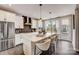 White kitchen with center island, stainless appliances, and quartz countertops at 207 Tamala St, Davidson, NC 28036