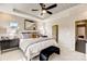 Main bedroom with king bed, tray ceiling, and access to the bathroom at 207 Tamala St, Davidson, NC 28036
