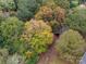 Close-up aerial view of the property, highlighting the trees and a parked vehicle at 3417 Beaty Rd, Gastonia, NC 28056