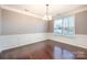 Formal dining room with hardwood floors, chair rail, and large windows at 501 Riviera Pl, Rock Hill, SC 29730