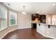 Bright kitchen features dark cabinets, granite countertops, and hardwood floors at 501 Riviera Pl, Rock Hill, SC 29730