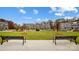 Two benches and a grassy area with townhomes in the background at 5544 Stafford Rd # 30, Charlotte, NC 28215