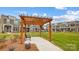 Wooden pergola with bench in a community green space at 5544 Stafford Rd # 30, Charlotte, NC 28215