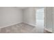 Simple bedroom with gray carpet and access to another room at 6346 Nandina Dr # 160, Harrisburg, NC 28075