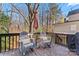 Relaxing deck with rocking chairs, umbrella, and wooded backdrop at 6701 Choppy Wood Cir, Charlotte, NC 28226